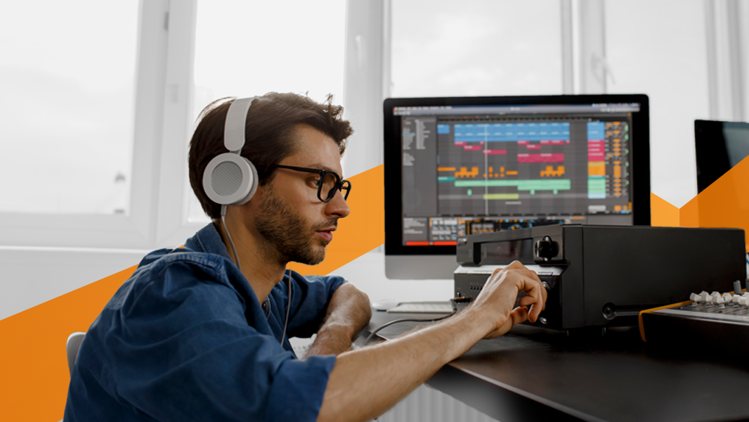 A professional audio technician working with various software and hardware devices